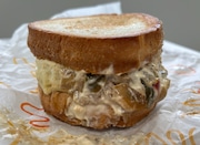 The Philly Melt from Burger King, featuring two burger patties with peppers and onions, Swiss cheese and "Royal" sauce on two pieces of toasted bread.