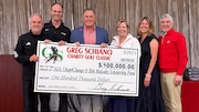Rutgers coach Greg Schiano poses with a $100,000 check following his annual charity golf outing at Fiddler's Elbow Country Club. (Courtesy of Rutgers Athletics).