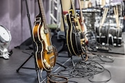 Guitars placed on stands ready for guitarists before a concert.