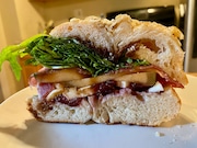 The Roma bagel sandwich from O'Bagel in Hoboken, featuring fresh mozzarella, prosciutto-wrapped cantaloupe, arugula, balsamic vinaigrette and homemade fig jam on a cacio e pepe bagel. (Jeremy Schneider | NJ Advance Media for NJ.com)