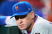New York Mets manager Carlos Mendoza pauses in the dugout prior to a baseball game against the Arizona Diamondbacks Monday, May 5, 2025, in Phoenix. (AP Photo/Ross D. Franklin)