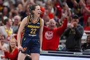 Indiana Fever guard Caitlin Clark (22) celebrates after a three-point basket a WNBA basketball game in Indianapolis.