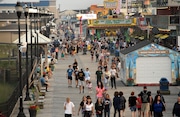 Visitors walk along the boardwalk in Seaside Heights in this file photo. After last year’s Memorial Day weekend at the Shore was marred by gangs of teens that brought violence and vandalism, several communities are ready if it happens again.