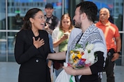 Mahmoud Khalil, right, speaks to Rep. Alexandria Ocasio-Cortez, D-N.Y., after arriving at Newark International Airport, Saturday, June 21, 2025, in Newark, N.J. (AP Photo/Seth Wenig)