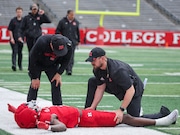 Rutgers athletic training staffers tend to Scarlet Knights wide receiver Famah Toure (1) who suffered an apparent knee injury on the first set of downs during the Scarlet-White game, Saturday, April 26, 2025 in Piscataway, N.J.