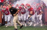 Rutgers head coach Greg Schiano leads the Scarlet Knights out of the tunnel to face Howard in the 2024 season-opener, Thursday, Aug. 28, 2024, in Piscataway, N.J.