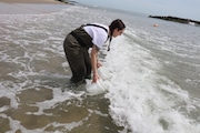 Danielle Hickson harvesting water from the shores of Asbury Park beach (Lauren Musni|NJ Advance Media)