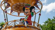 An actor portraying Mickey Mouse waves to visitors during a parade at Magic Kingdom Park at Walt Disney World Resort in Lake Buena Vista, Florida, on Monday, April 18, 2022.